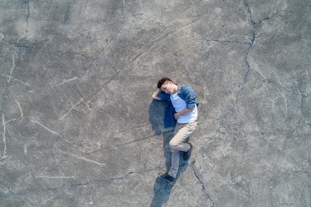 aerial shot of man feel upset and lying on the floorの写真素材