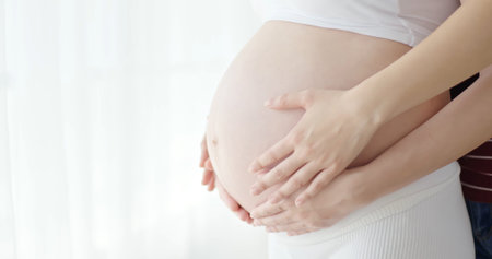 close up of pregnant women belly at home