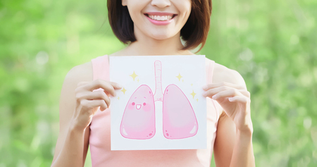 woman take health lung billboard and thumb up with green backgroundの写真素材