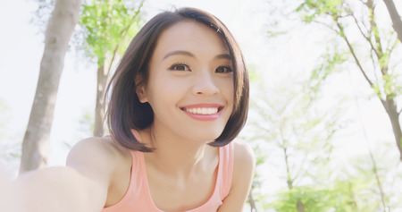 sport woman selfie happily in the forestの写真素材