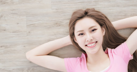 woman smile happily and lying on floorの写真素材