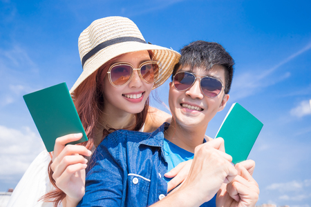 couple take passport with the blue skyの写真素材