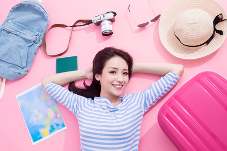 beauty woman smile happily and lying on pink floorの写真素材