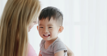 mommy hug her son and smile happily at homeの写真素材