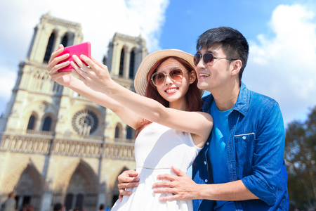couple travel to Notre Dame and selfie happilyの写真素材