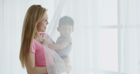 mommy hug her son and smile happily at homeの写真素材