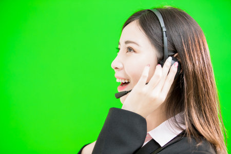 businesswoman wear phone headset on the green background