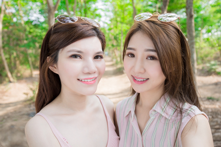 two beauty women wear brace and retainer for teeth selfie happilyの写真素材