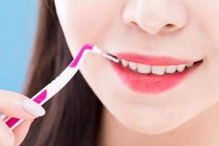 close up of woman take interdental brushの写真素材