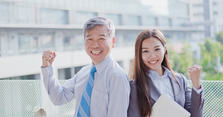 business people look you and smile happilyの写真素材