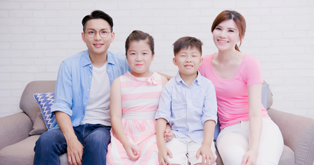happily family smile to you at homeの写真素材