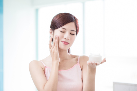 beauty woman with moisturizer concept in the bathroomの写真素材