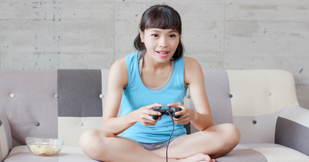 woman play video game and feel happily at homeの写真素材