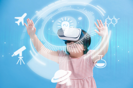 cute girl wear vr learning science isolated on the blue backgroundの写真素材