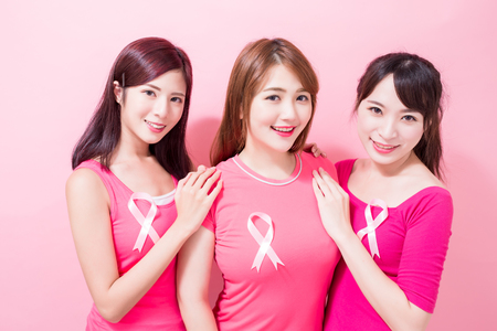 women with breast cancer prevention on the pink backgroundの写真素材