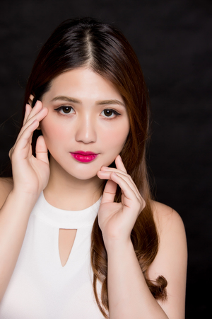 beauty woman touch her face on the black backgroundの写真素材