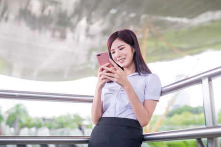 business woman smile happily and use phoneの写真素材