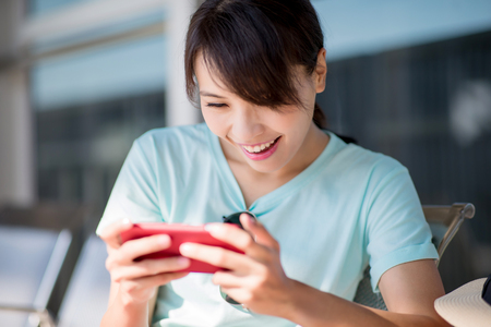 woman use phone and play mobile game in the Stationの写真素材