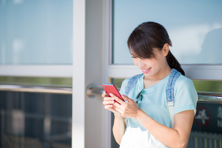 woman stand and use phone happily in the Stationの写真素材
