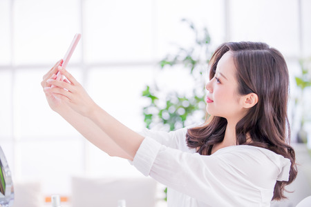 Beauty woman take a selfie at homeの写真素材