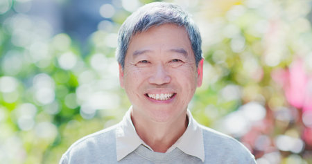 old man smile to you with nature green background
