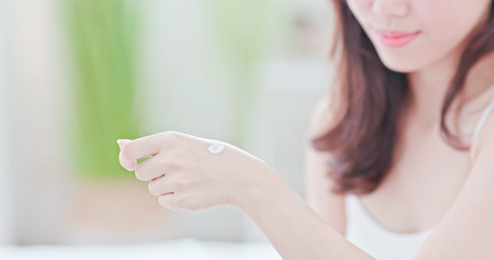Young beauty asian woman applying hand cream at homeの写真素材