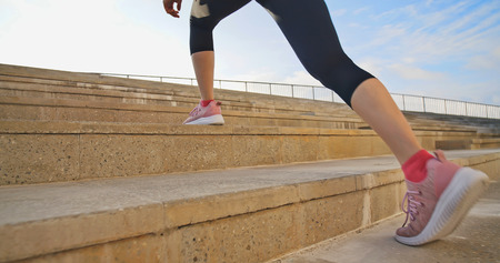 closeup of woman sport and run on stairsの写真素材