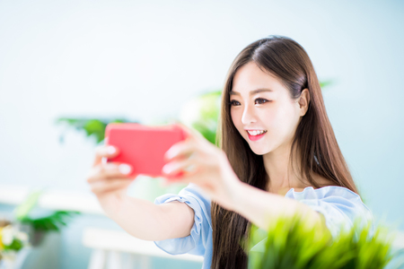 young asian woman selfie happy at homeの写真素材