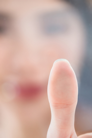 Close up of woman scanning fingerprint on screen and unlock a digital deviceの写真素材