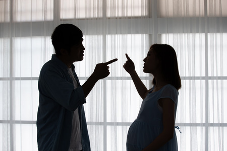 pregnant couple arguing and quarreling at homeの写真素材