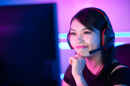 Young Asian Pretty Pro Gamer Playing in Online Video Gameの写真素材