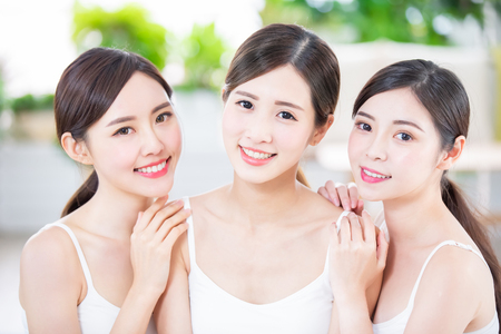 Smiling asian women friend enjoying the skin care in the spa salonの写真素材