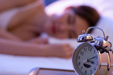 asion young woman sleep well with clock