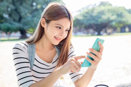 asian student use the smart phone in the school
