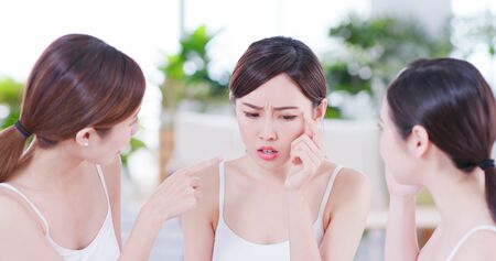 Smiling asian women friend are chat about the skin problemの写真素材