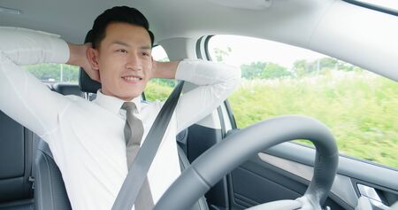 confident business asian man experience to riding an autonomous self driving carの写真素材