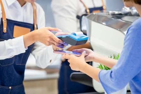 mobile payment concept - close up of pay bills by Phone to Credit Card System