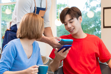 mobile payment concept - man Pays bills by Phone to Credit Card Systemの写真素材