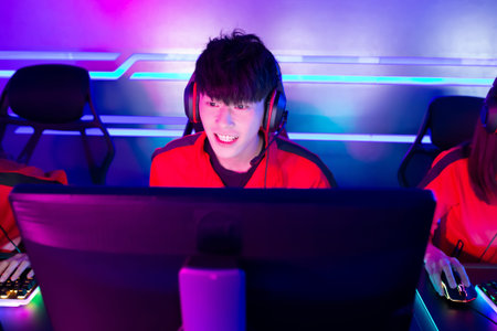 young asian teenage cyber sport gamer play in multiplayer PC video game on eSport tournament