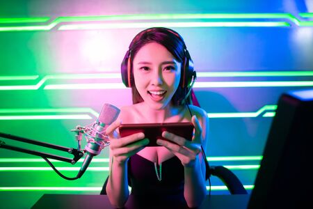 asian girl have live stream and playing mobile game on the smartphoneの写真素材