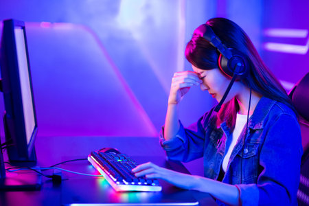 Young asian esport gamer girl feel painful while playing in Online Video Game because her eye is...