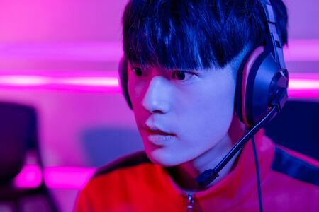 young asian teenage cyber sport gamer play in multiplayer PC video game on eSport tournamentの写真素材
