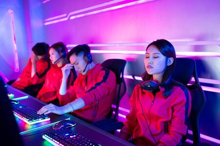 Team of asian teenage cyber sport gamers lose the multiplayer PC video game on eSport tournament and feel upsetの写真素材