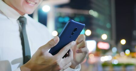 close up of businessman use 5g smart phone outdoor in the eveningの写真素材