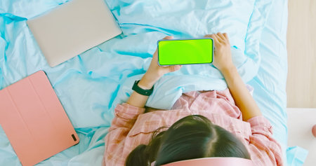 top view of asian woman use smartphone to watch video