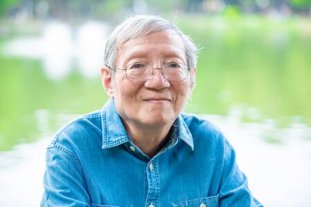 asian elder man look to you in the parkの写真素材