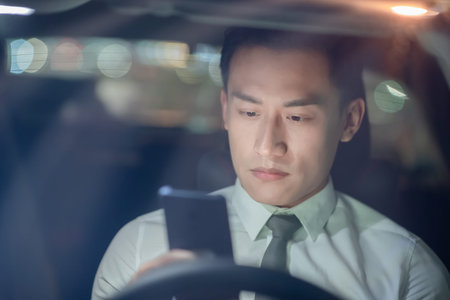 asian businessman feel tired and depressed after using smartphone in the car