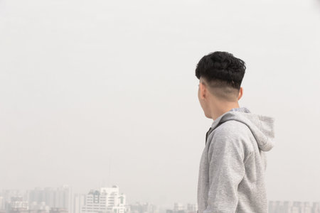 asian man look something and worry about air pollution or transmissible infectious diseases in the...