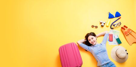 beauty woman smile happily and lying on yellow floorの写真素材