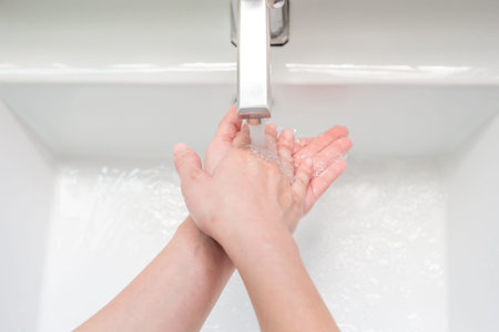 top view close up of wash hands with water to prevent the spread infectious disease coronavirus with...